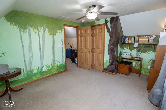 carpeted bedroom featuring a textured ceiling, ceiling fan, and lofted ceiling