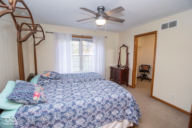 bedroom featuring carpet flooring, a walk in closet, and ceiling fan