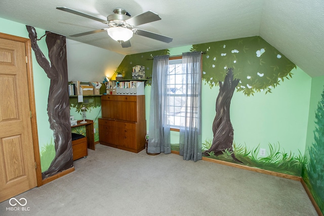 carpeted bedroom featuring ceiling fan, a textured ceiling, and vaulted ceiling