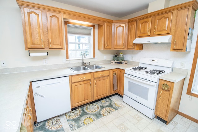 kitchen with backsplash, sink, and white appliances