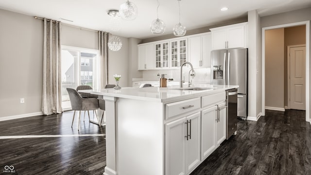 kitchen with dark hardwood / wood-style flooring, white cabinetry, a center island with sink, and sink