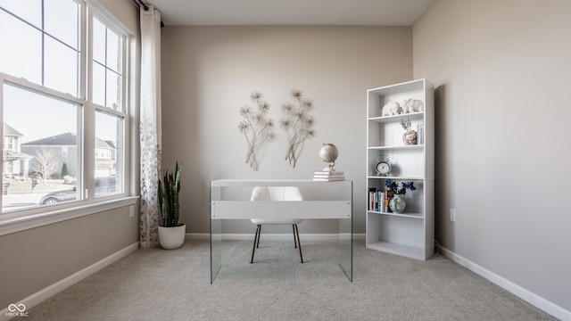 office area with a healthy amount of sunlight and light carpet