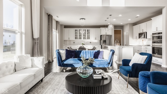 living room featuring plenty of natural light, hardwood / wood-style floors, and sink