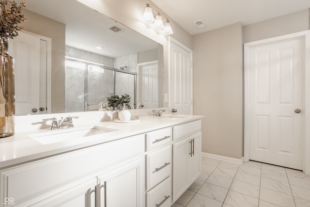 bathroom with a shower with door and vanity