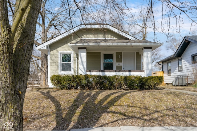 bungalow-style home featuring covered porch and central AC