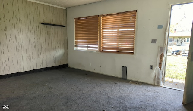 unfurnished room with dark carpet