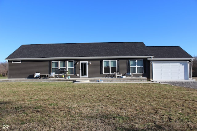 ranch-style house featuring a garage and a front yard