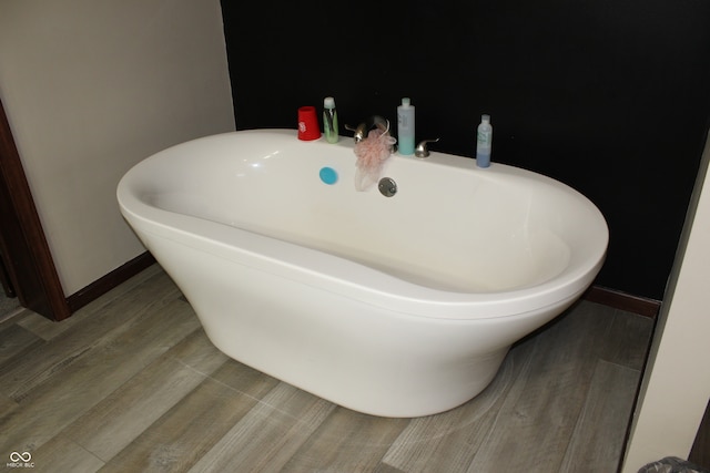 bathroom featuring a washtub and hardwood / wood-style floors