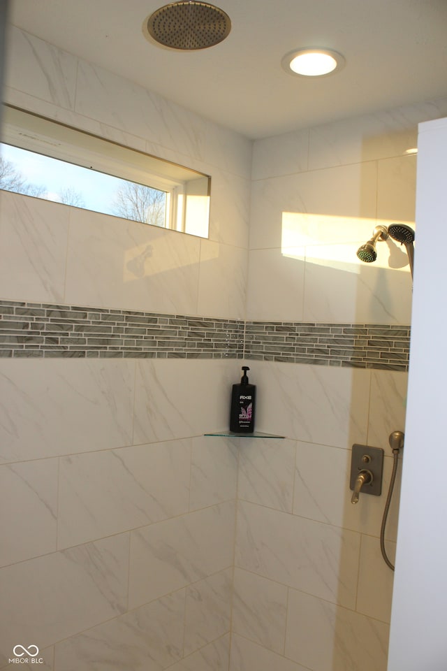 bathroom with a tile shower