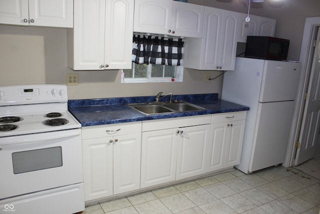 kitchen with white appliances, sink, light tile patterned floors, and white cabinets