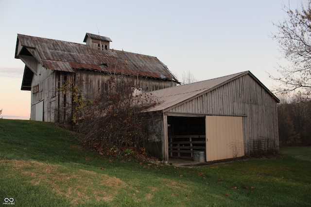 outdoor structure at dusk with a lawn