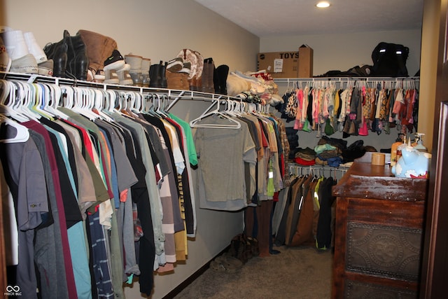 walk in closet featuring carpet flooring