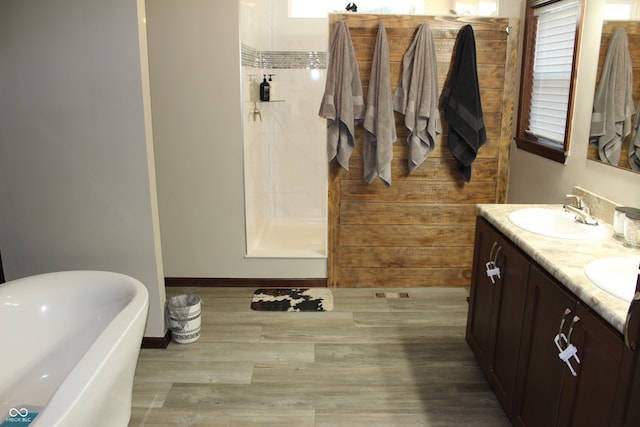 bathroom featuring vanity, a bath, and hardwood / wood-style flooring