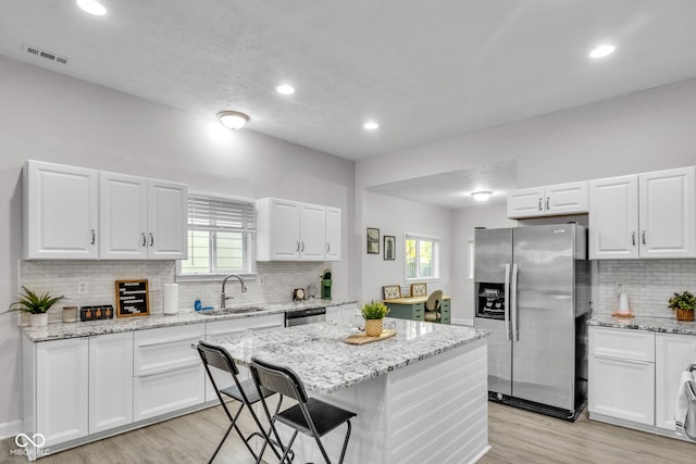 kitchen with white cabinetry, sink, a healthy amount of sunlight, and appliances with stainless steel finishes