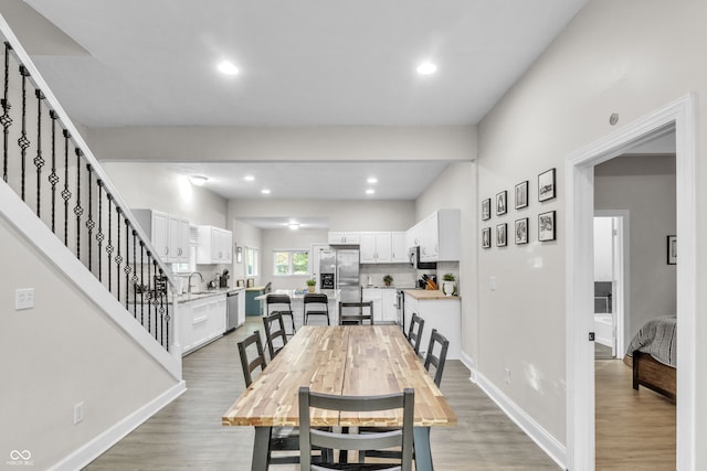 dining room with light hardwood / wood-style flooring and sink