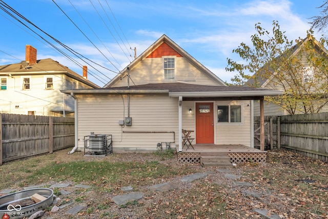 rear view of house featuring central AC and a wooden deck