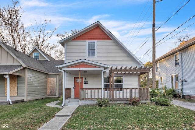 view of front of property featuring a front yard and a pergola