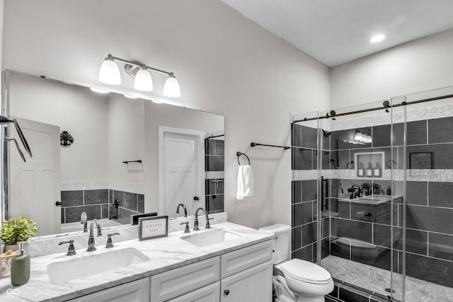 bathroom featuring toilet, vanity, and walk in shower