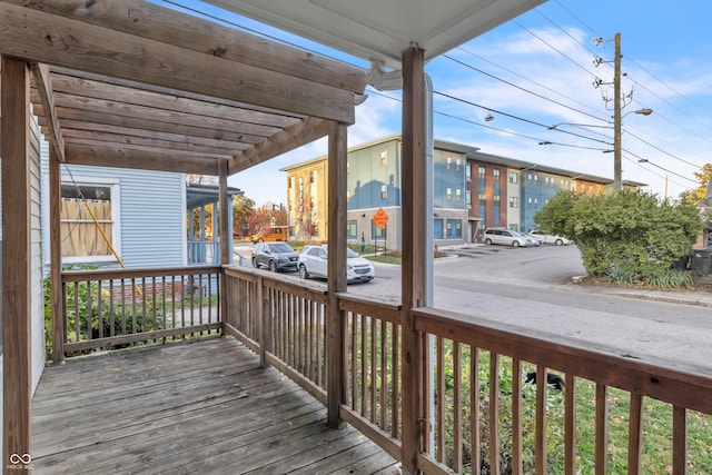 wooden terrace featuring a porch and a pergola