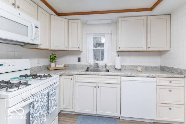 kitchen with sink, white appliances, white cabinets, and light hardwood / wood-style floors