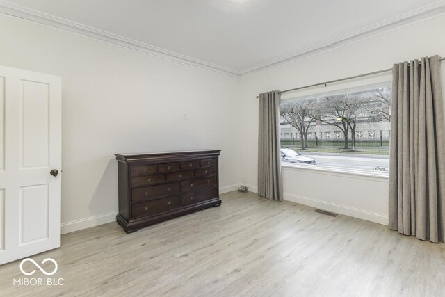 907 S E St, Indianapolis, IN 46225 - unfurnished bedroom with crown molding and wood finished floors