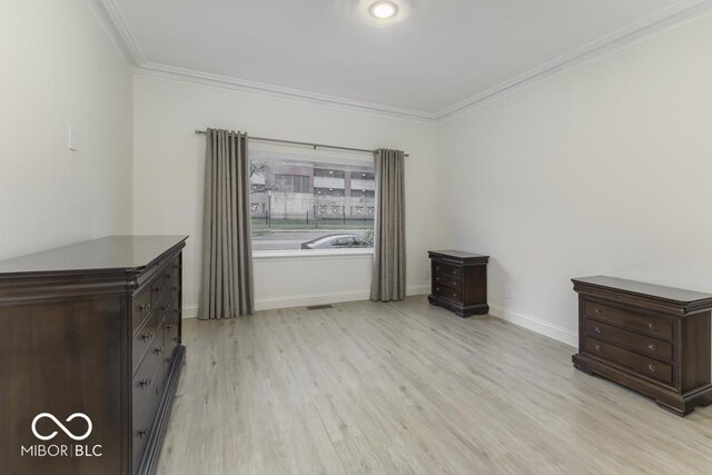 907 S E St, Indianapolis, IN 46225 - unfurnished bedroom with ornamental molding and light wood-style floors