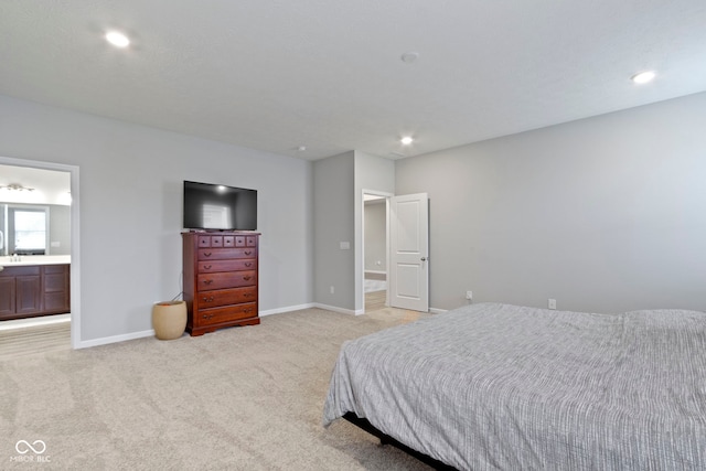 carpeted bedroom featuring ensuite bath