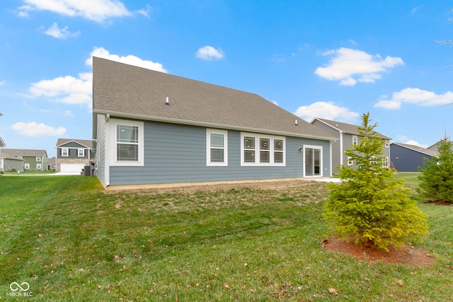 rear view of house with a yard