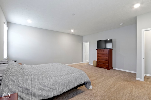 bedroom featuring light colored carpet