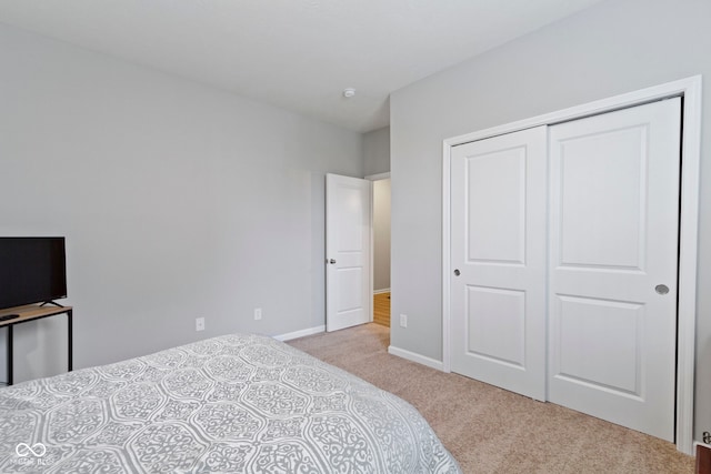 carpeted bedroom with a closet