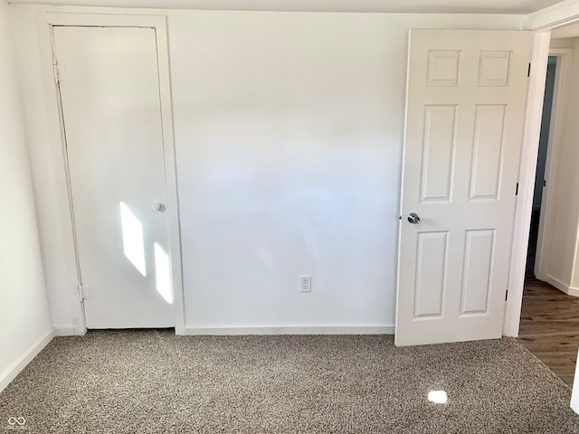 unfurnished bedroom with dark hardwood / wood-style floors