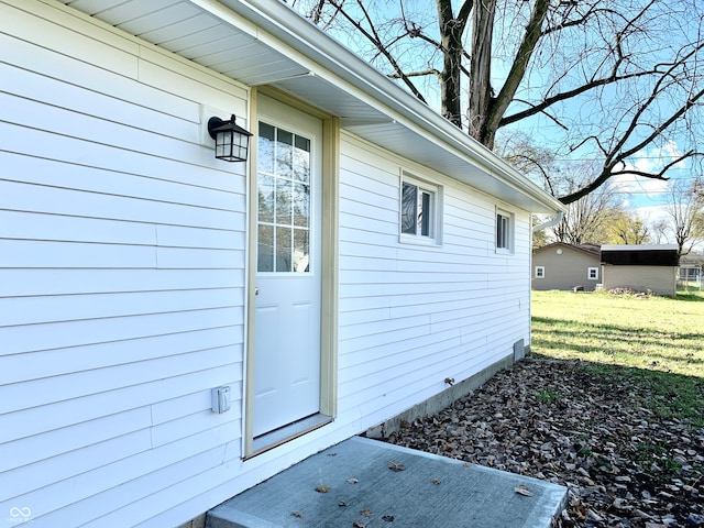 doorway to property featuring a yard