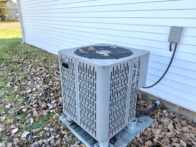 exterior details featuring central AC unit and wooden walls