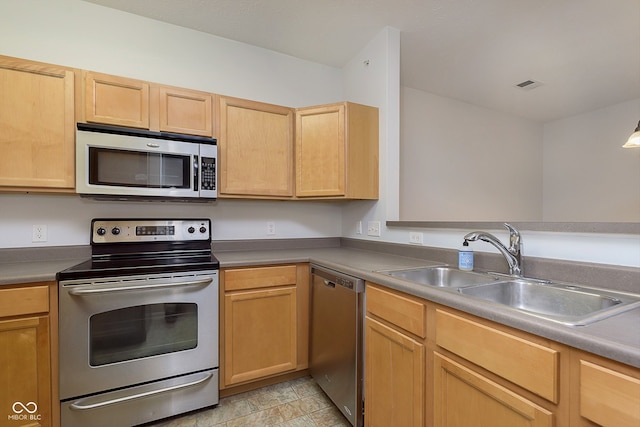 kitchen featuring sink, stainless steel appliances, and light brown cabinetry