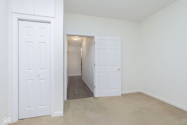 unfurnished room featuring light colored carpet