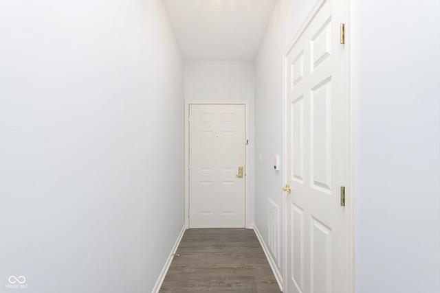 hallway with dark wood-type flooring