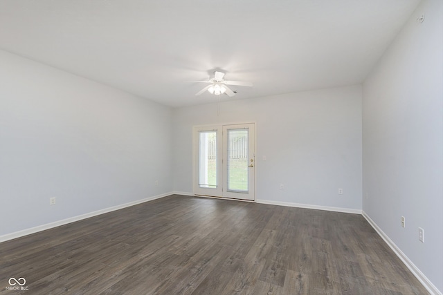 empty room featuring ceiling fan and dark wood-type flooring