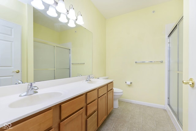 bathroom with vanity, toilet, and an enclosed shower