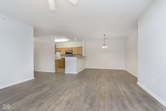 unfurnished living room featuring ceiling fan and wood-type flooring