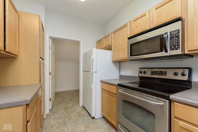 kitchen with light brown cabinetry and stainless steel appliances