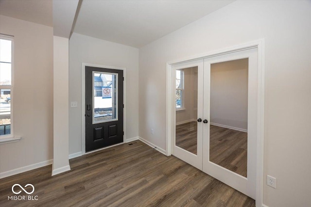 entryway featuring french doors and dark wood-type flooring