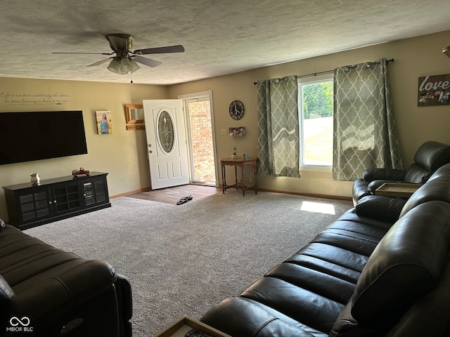 living room featuring carpet flooring, a textured ceiling, and ceiling fan