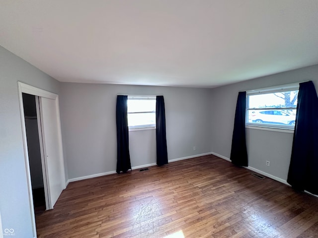 unfurnished bedroom with wood-type flooring and a closet