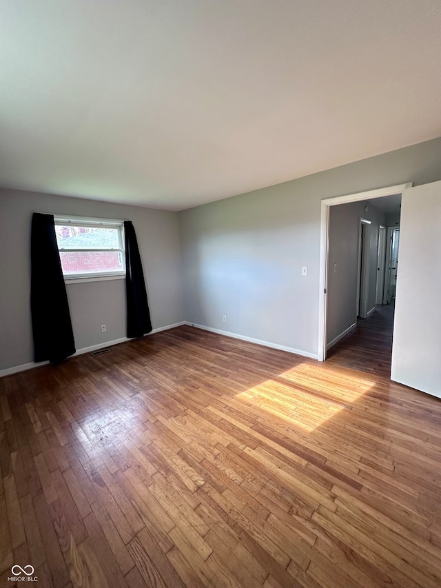 empty room featuring wood-type flooring