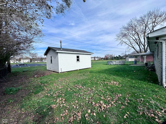 view of yard featuring an outbuilding and central AC unit