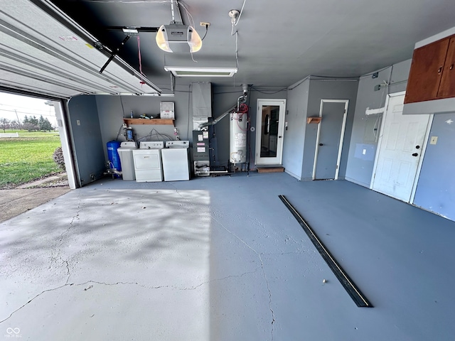 garage with a garage door opener, gas water heater, washer and clothes dryer, and heating unit