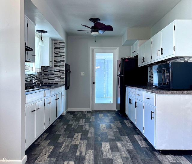 kitchen featuring sink, dark hardwood / wood-style floors, black appliances, white cabinets, and decorative backsplash