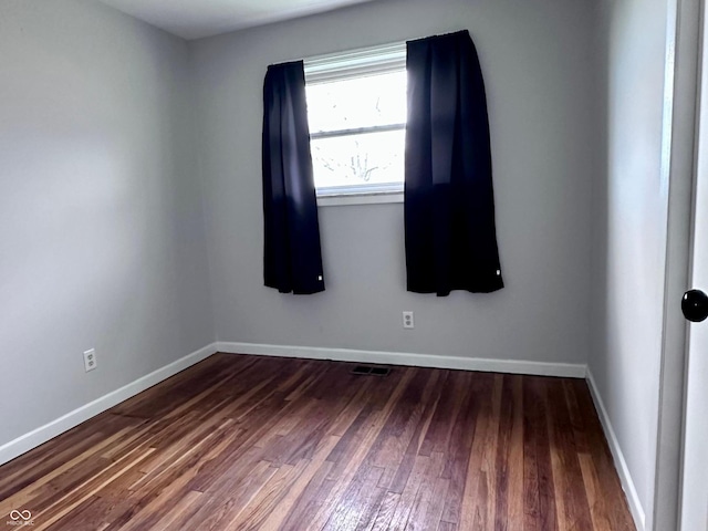 unfurnished room featuring dark hardwood / wood-style flooring