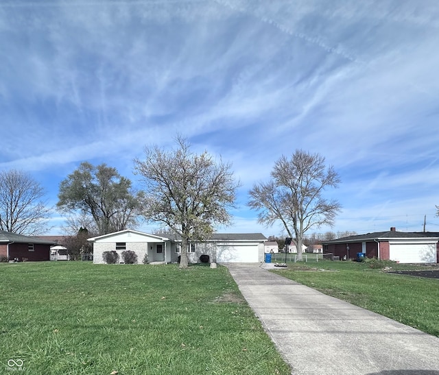 ranch-style home with a garage and a front lawn