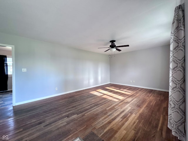 empty room featuring dark hardwood / wood-style flooring and ceiling fan